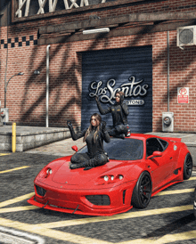 two women sit on top of a red sports car in front of a los santos customs building