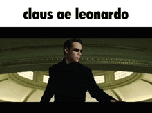 a man in a suit and sunglasses with the words claus ae leonardo written above him