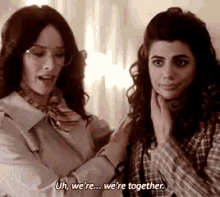 two women are standing next to each other and one of them is saying `` we 're together '' .