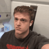 a man taking a selfie with a shirt that says ' crazy ' on the front