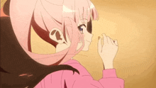 a girl with pink hair is wearing a pink sweater .