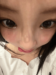 a close up of a woman 's face with her eyes closed