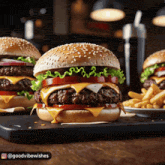 a double cheeseburger with lettuce and tomato on a sesame seed bun
