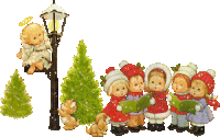 a group of children singing christmas carols next to a lamp post