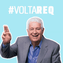 a man in a suit and blue shirt is giving a thumbs up with #voltareq above him