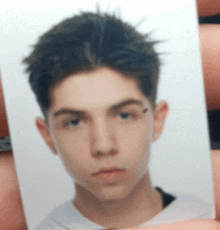 a close up of a young man 's face with a white background