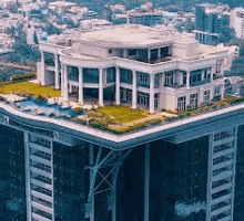 an aerial view of a large building with a swimming pool on the roof .