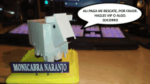 a figurine of a sheep with a sign that says monicabna naranjo