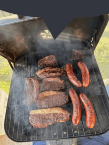 a grill with steaks and sausages on it