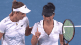 two female tennis players one wearing a shirt that says lotto on it