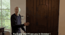 a man standing in front of a door with the words " fuck you and i 'll see you in october " written on it