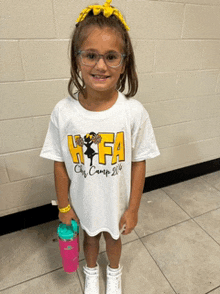 a little girl wearing a white shirt with hfa on it