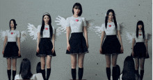 a group of girls with wings on their shirts