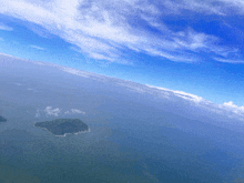 an aerial view of a small island in the middle of a body of water