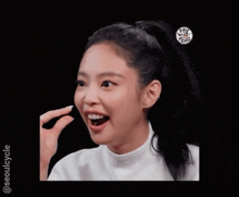 a woman with a ponytail is smiling with her mouth open
