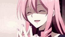 a girl with pink hair is smiling with her eyes closed and her hands together .