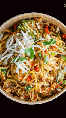 a close up of a bowl of noodles with vegetables