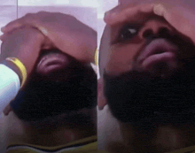 a man with a beard has his hands on his face