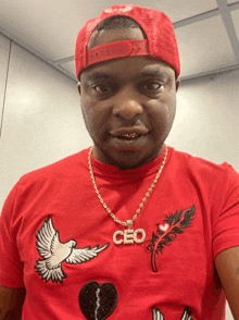 a man wearing a red shirt with the word ceo on the front