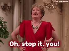 a woman in a red dress with her hands on her hips says oh stop it you