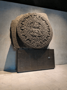 a large stone sculpture with a circular design that says ' a ' on it