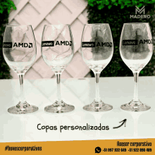 a row of wine glasses with lenovo amd written on them