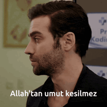 a man with a beard and the words allah 'tan umut kesilmez