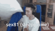 a man wearing headphones sits in a chair with the words sex81 ( sleepy time ) above him