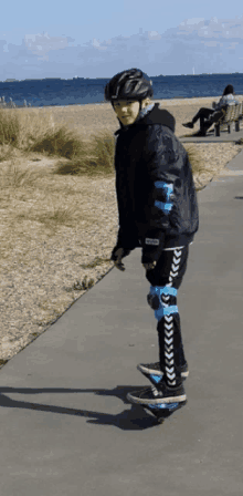 a young boy wearing a helmet is riding a skateboard