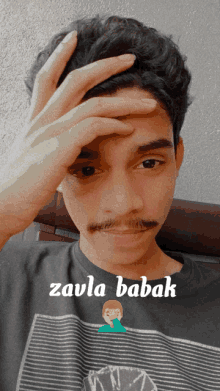 a young man with a mustache is wearing a black shirt that says zaula babak