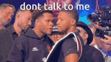 two men standing next to each other with the words " dont talk to me " written above them