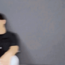 a blurry picture of a man wearing a black shirt and white shorts .
