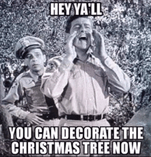 a black and white photo of two police officers with the caption hey ya 'll you can decorate the christmas tree now .