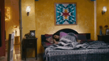 a woman is laying on a bed with a clock on the nightstand .