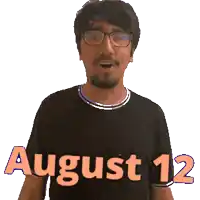 a man wearing glasses and a black shirt with the words august 12 on it