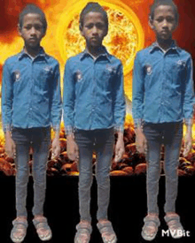 three young boys are standing in front of a fire .