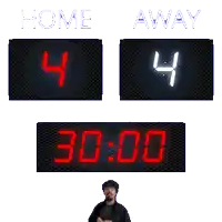 a man stands in front of a scoreboard that reads home 4 away 4