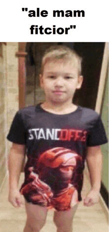 a young boy wearing a black shirt that says standoff 2