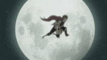 a man and a woman are flying in front of a full moon .