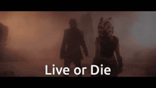 a silhouette of a man and a woman with the words " live or die " above them