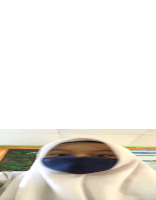 a person wearing a white hijab and a blue mask is looking at the camera .