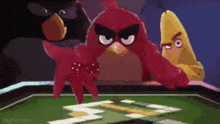 a group of angry birds are playing a game of cards .