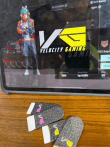 a tablet with a velocity gaming logo on the screen