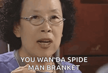 a woman wearing glasses and a blue shirt says you wan da spide man branket
