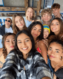 a group of young people posing for a selfie