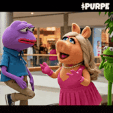 a purple frog and a pink pig are talking to each other in a mall