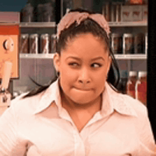 a woman wearing sunglasses and a headband is making a funny face in a restaurant .