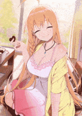 a girl with a braided hair is smiling and holding a heart shaped cookie in her hand