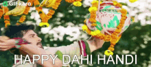 a man is holding a ball in his hand with the words happy dahi handi written below him .