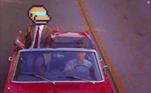 a man in a suit and tie is driving a red car with a pixelated monkey head on the windshield